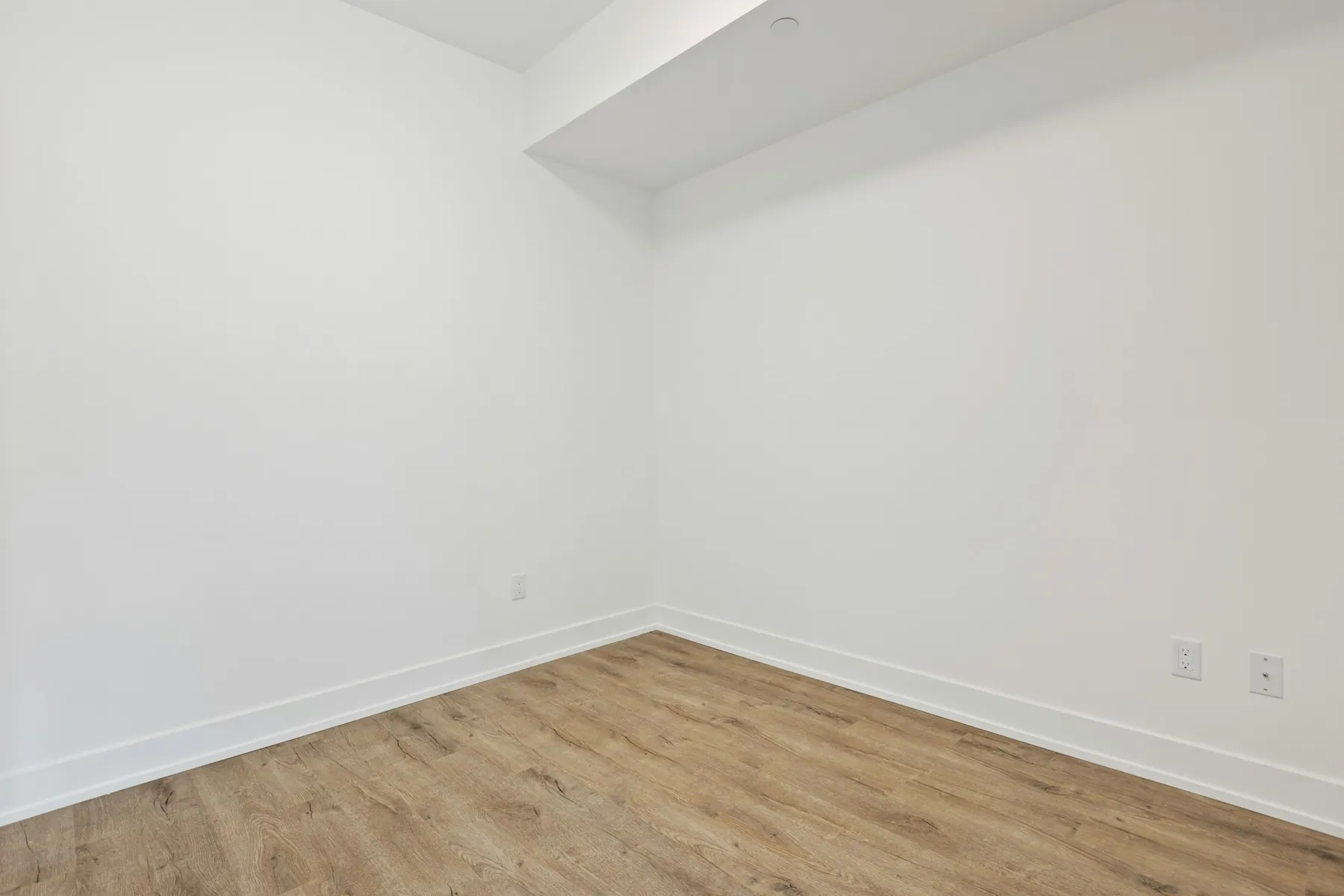 Before: empty living room with plain painted walls