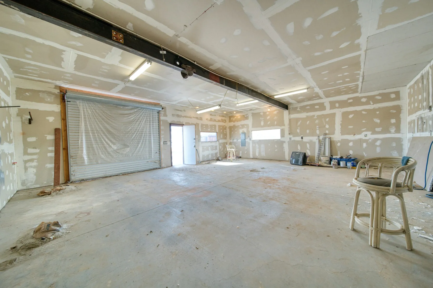 Before: unfinished commercial space with taped drywall